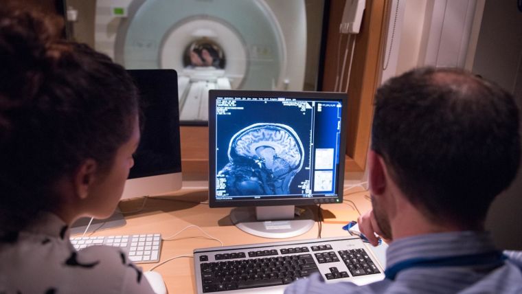 Two people working at a MRI