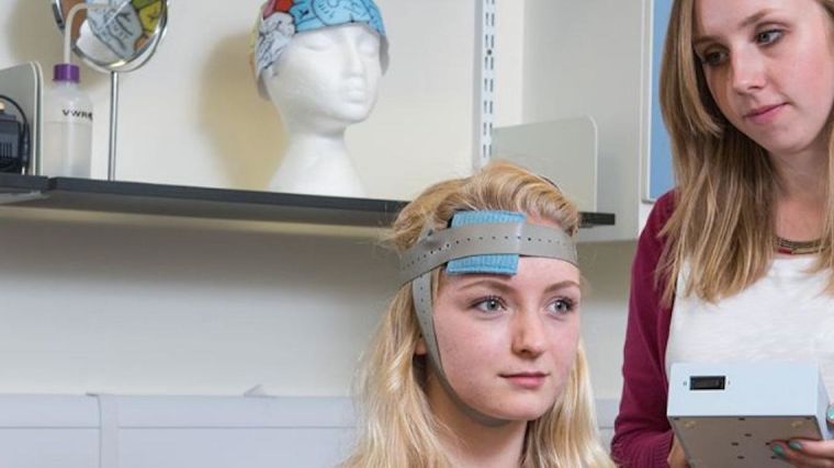 Transcranial Electrical Stimulation (tES) involves passing a small electric current through the skull and the underlying cortex via two rubber electrodes.
